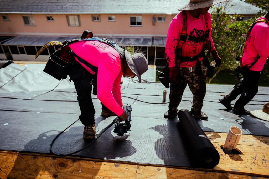 Roofers laying roof padding